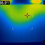 FLIR image of the bottom of the laptop. There is a "V" shape stretching from the top corners to about halfway down the laptop. This entire "V" shape is light green (34 C) to yellow (37 C). Around the "V" shape is a light blue (31 C) area, and the bottom corners of the laptop are dark blue. There is an indicator stating that the highest recorded temperature is 36.9 degrees celcius, though this appears to be the temerapture of the table surface next to the primary vents. The highest temperature on the laptop surface is a bit cooler.