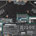 The same image of the internals of the laptop, but with the M.2 drive slots and RAM slots highlighted with green rectangles around them.