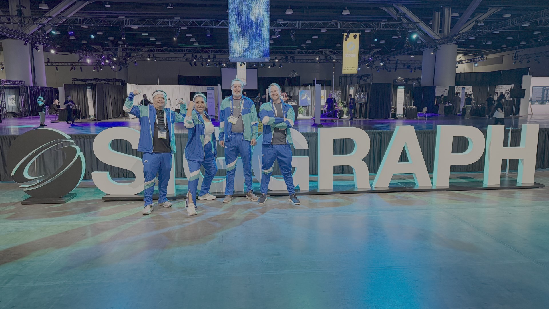 Puget Systems staff posing in front of "SIGGRAPH" sign at event entrance